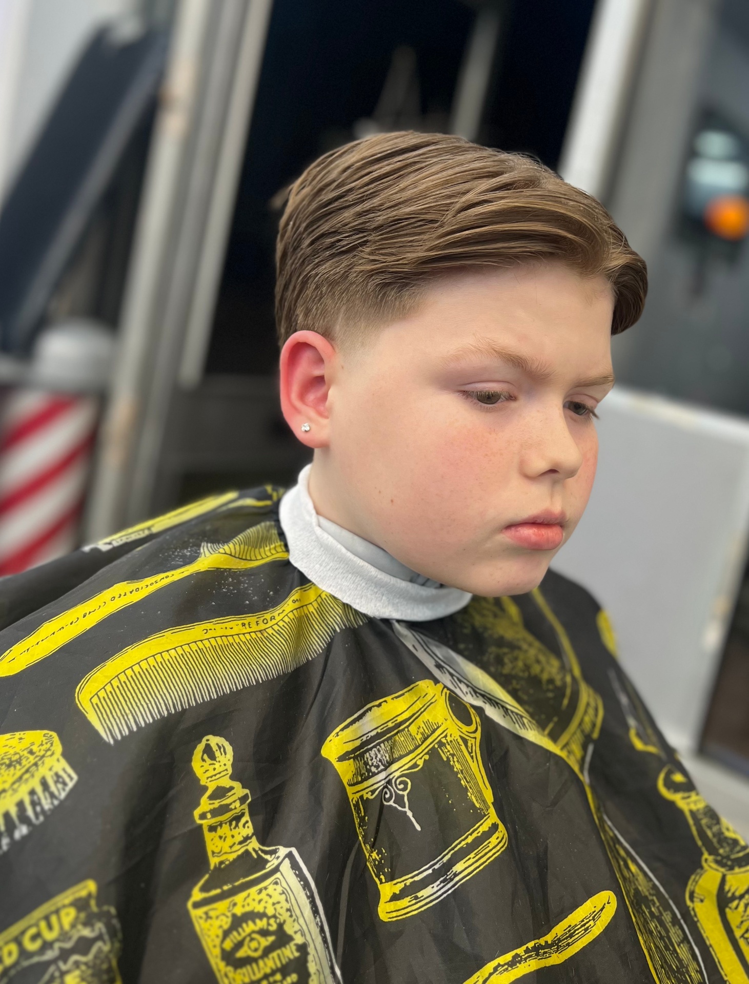 Side-swept textured cut with taper fade by Legends Barbers