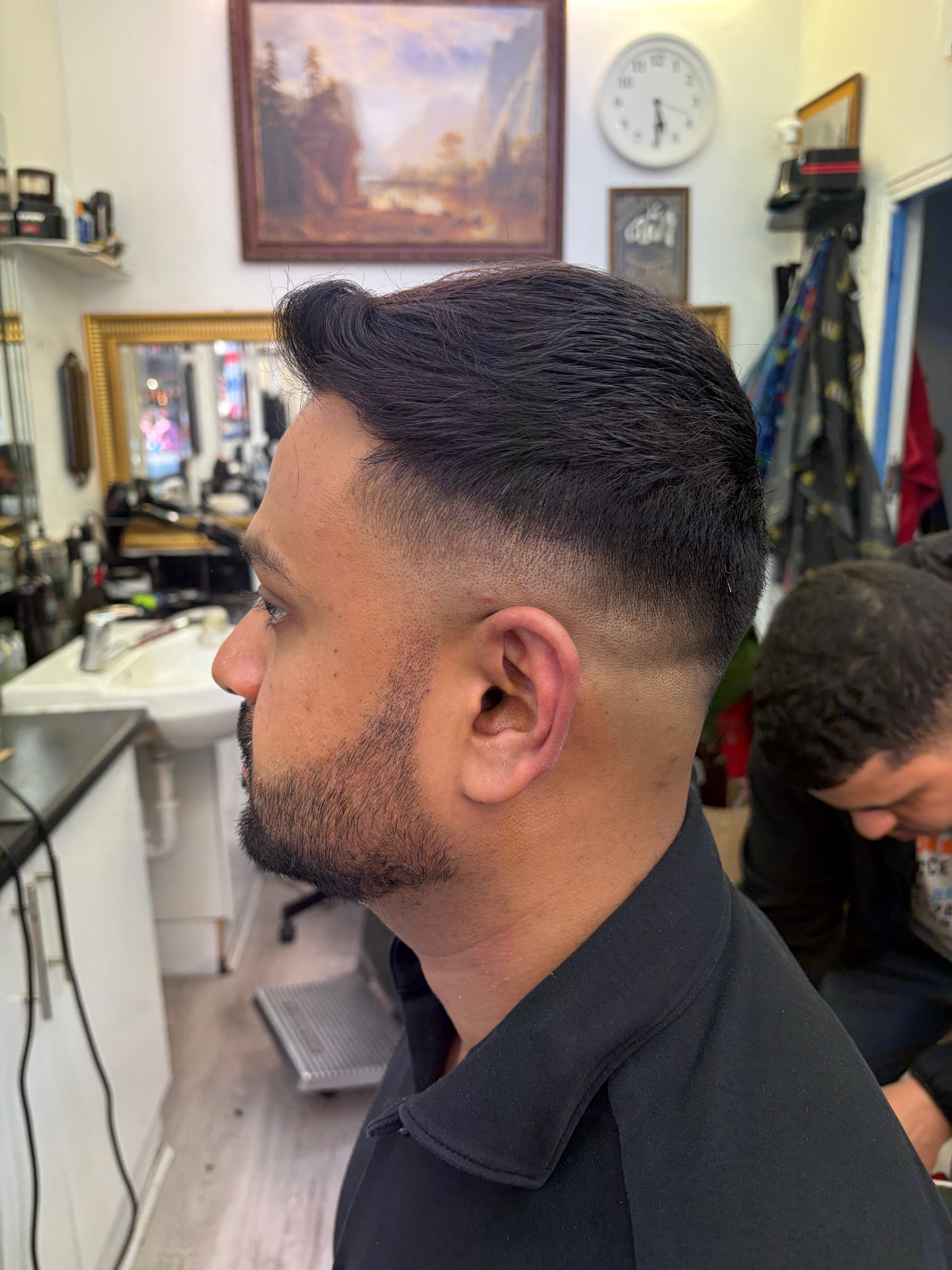 High-volume quiff with skin fade by Legends Barbers